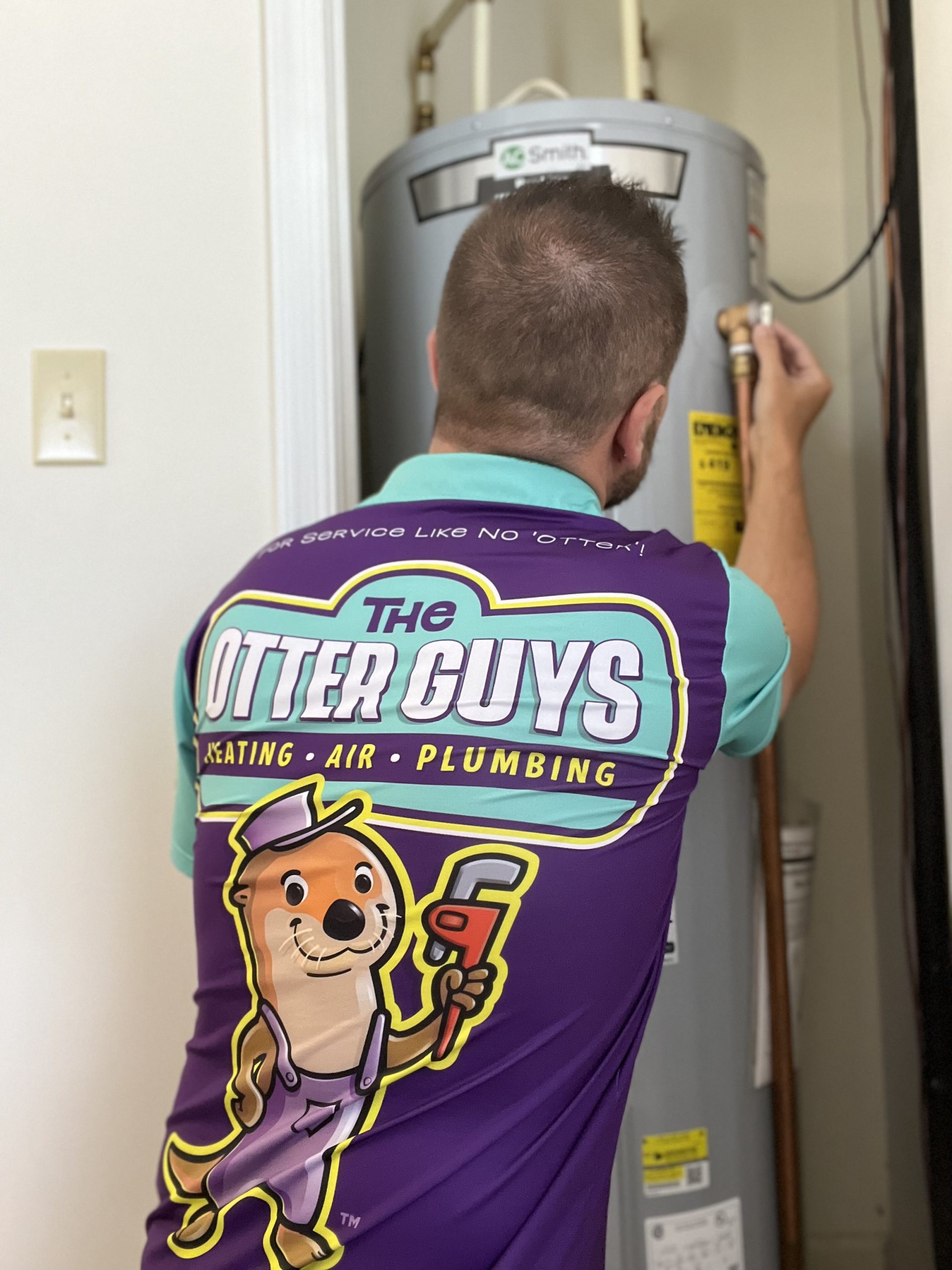 Otter Guys plumber working on a water heater installation