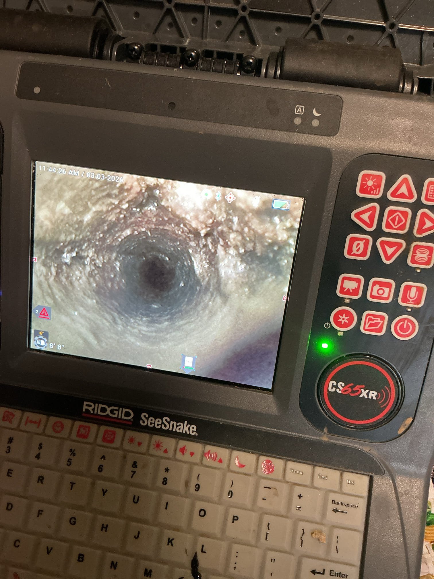 Otter Guys technician showing homeowner sewer camera inspection results